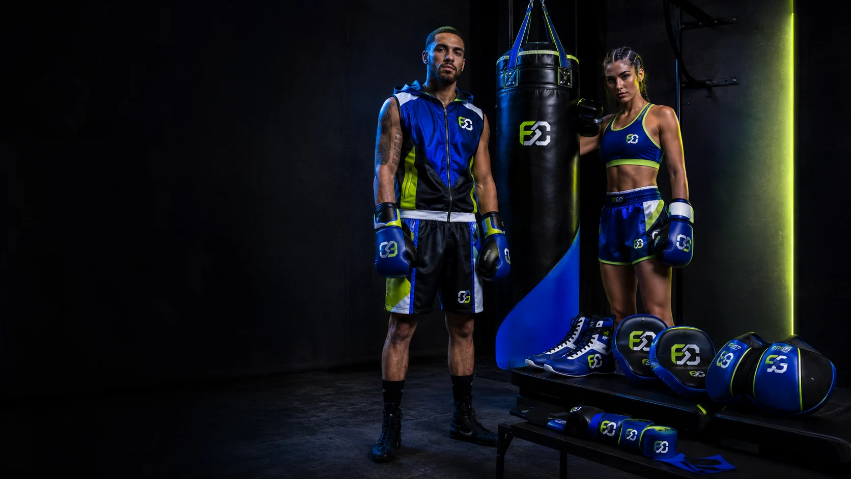 Two boxers in blue and lime kit beside a heavy bag and a row of gloves